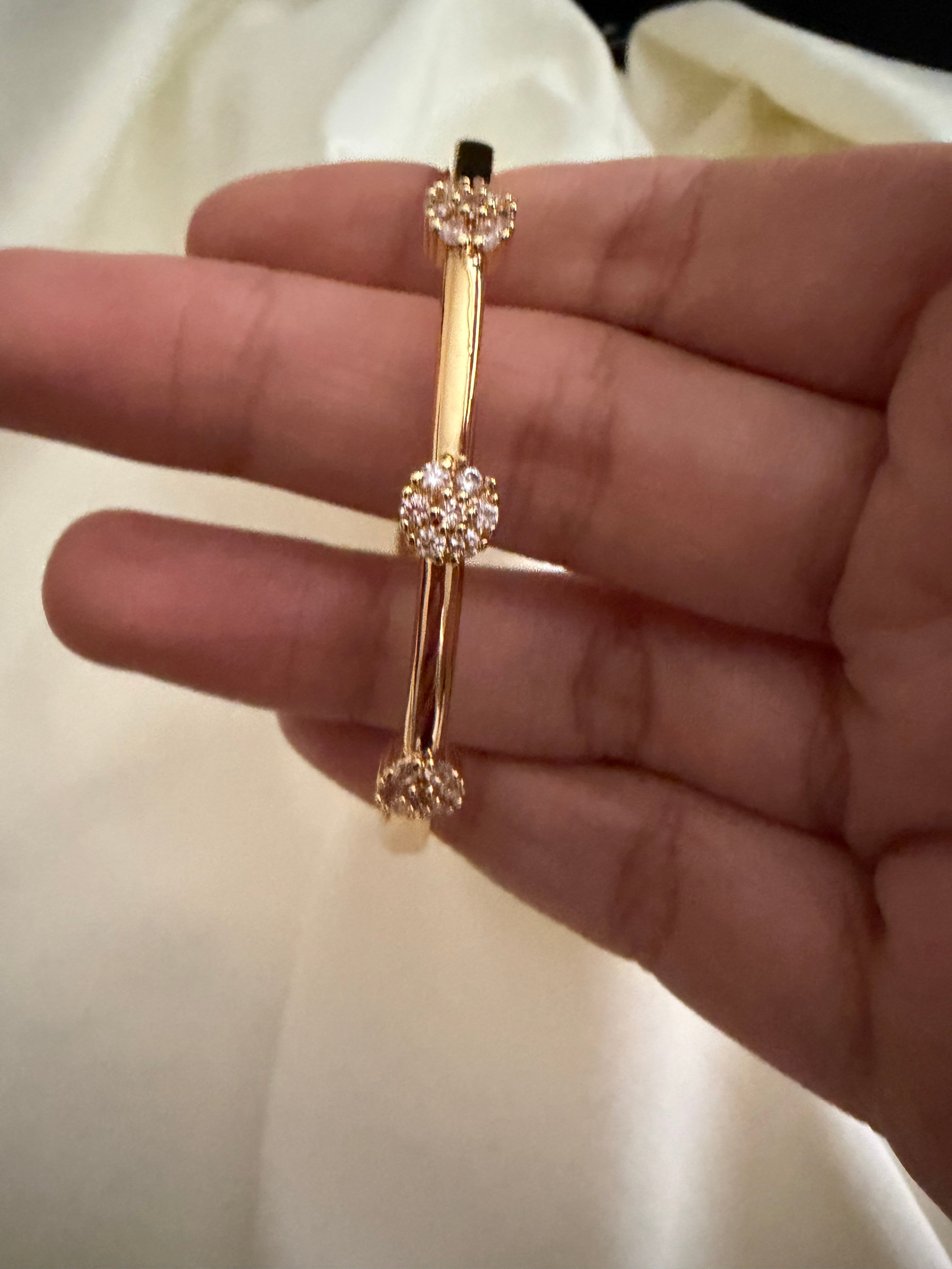 Gold plated bangle with rhinestone flowers