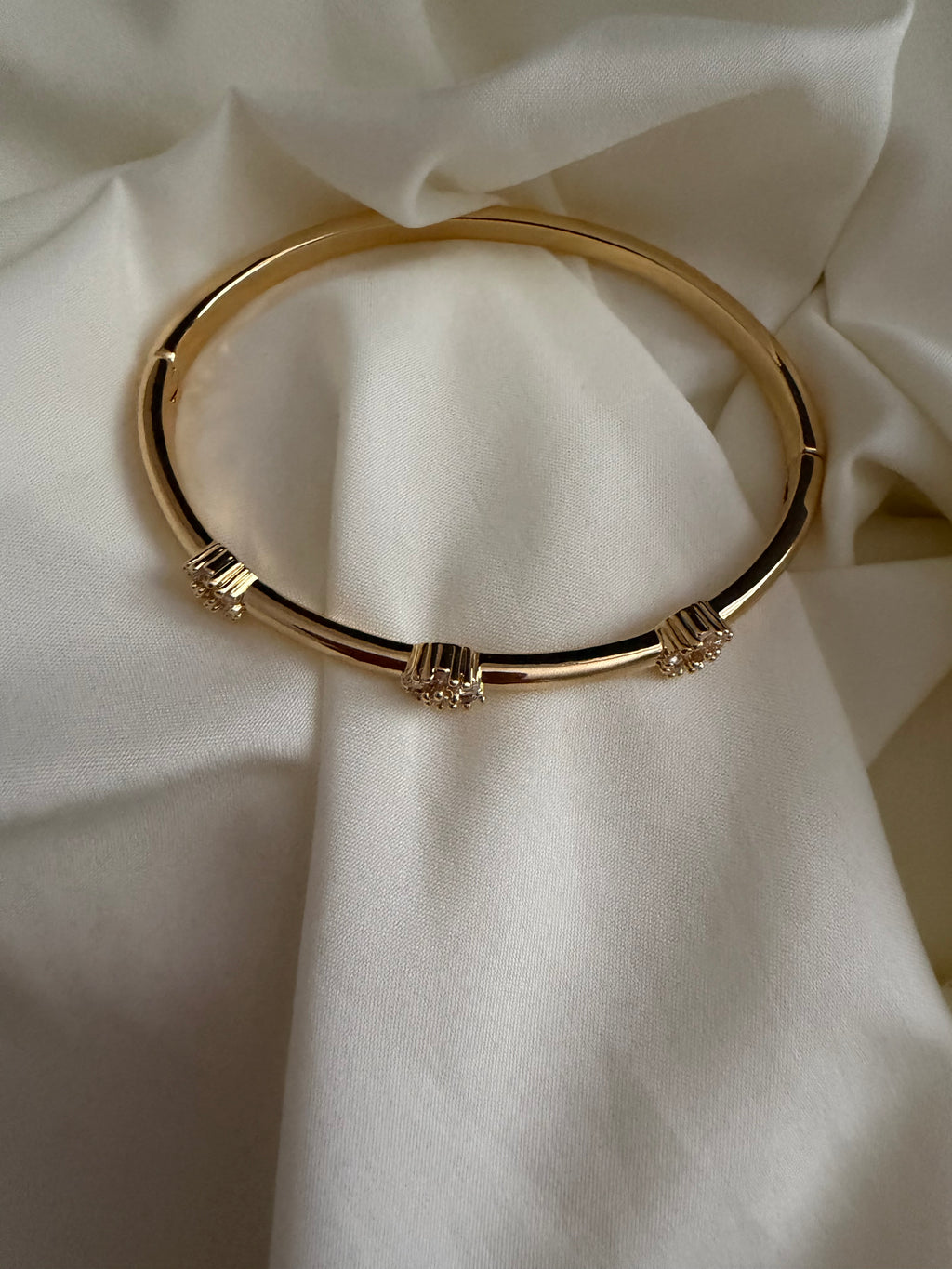 Gold plated bangle with rhinestone flowers